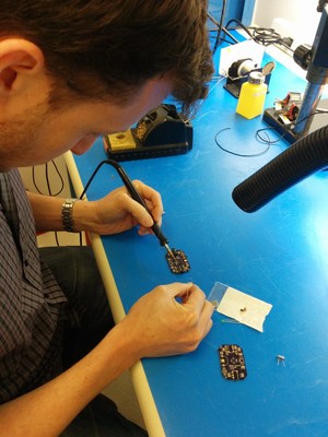 Eithan soldering the through hole components.